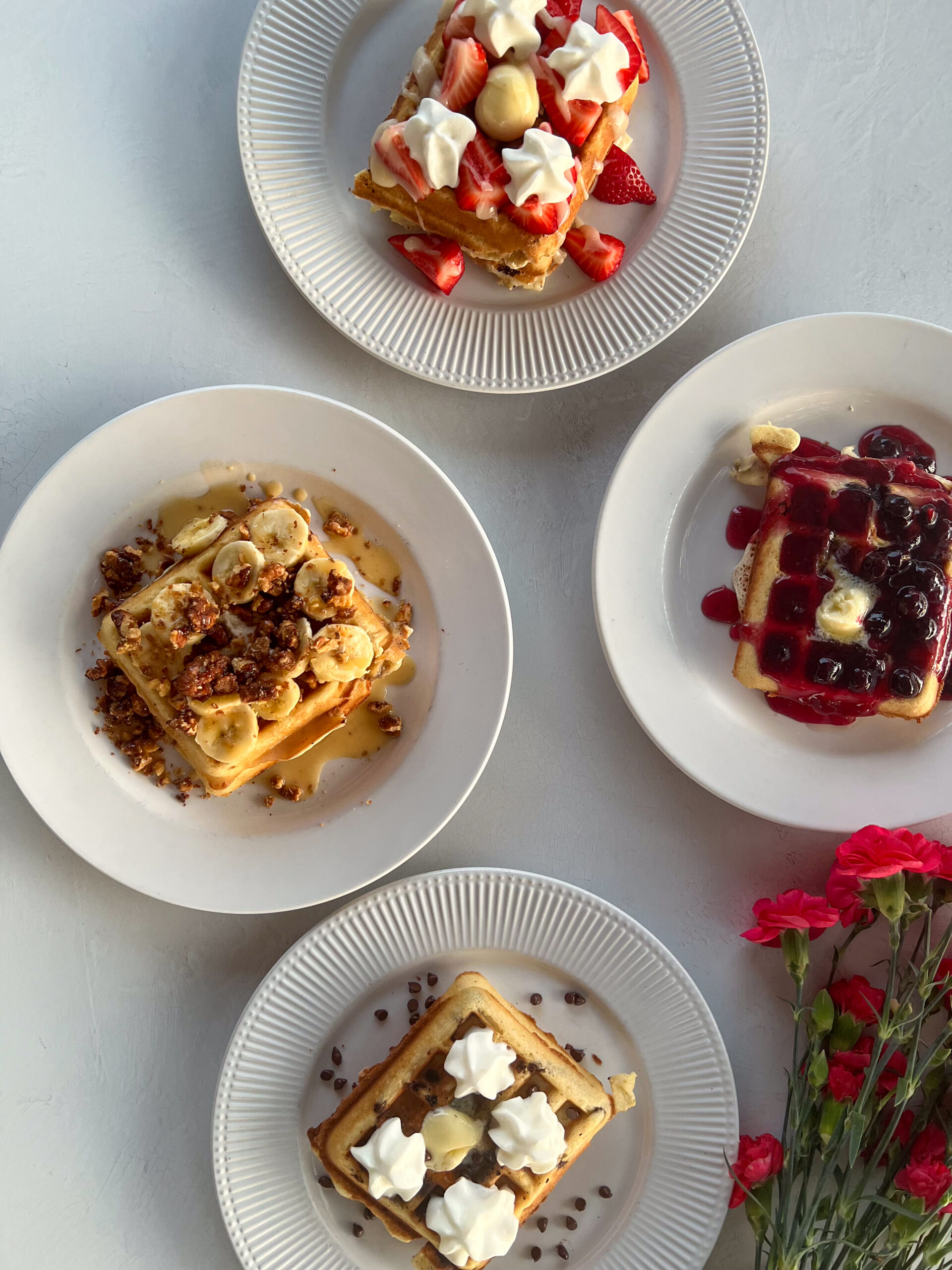 four different specialty waffles – blueberry, banana walnut, strawberry and chocolate chip